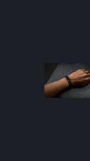 Man's wrist with stone bracelets — mobile hero background